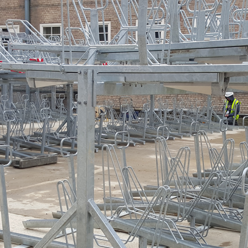 Rows of empty double-layer bike storage racks, outdoors.