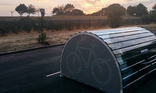 A dome-roofed Bikehangar storage container on the side of a road.